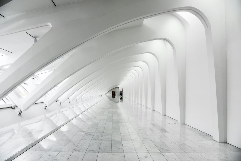 A communal hallway in a managed residential building with plain doors and clear flooring.