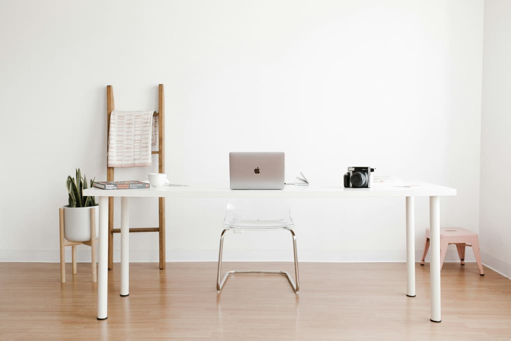 A clean, well-lit office corridor with plain walls and an uninterrupted floor.